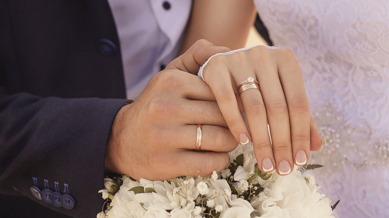 Couple Wearing Wedding Rings 